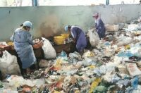 Image of women sorting garbage for recycling in India.